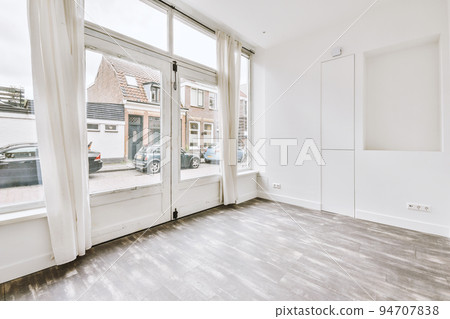 Plastic window and radiator on white wall in empty light room at home Plastic window and radiator on white wall in empty light room at home 94707838