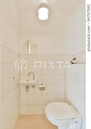 Modern home interior design of white bathroom with open bathtub and shower separated from toilet by partition wall Modern home interior design of white bathroom with open bathtub and shower separated from toilet by partition wall 94707842