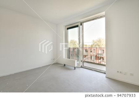 Interior of empty white kitchen with windows and wooden parquet floor Interior of empty white kitchen with windows and wooden parquet floor 94707933