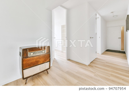 Interior of contemporary flat in minimal style with spacious hallway with white walls Interior of contemporary flat in minimal style with spacious hallway with white walls 94707954