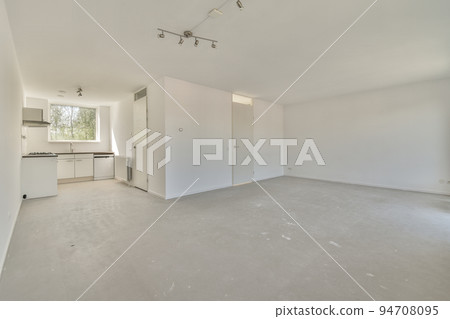 Interior of empty white kitchen with windows and wooden parquet floor Interior of empty white kitchen with windows and wooden parquet floor 94708095