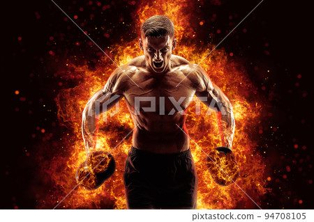 The shirtless abdominal male holds dumbbell. Studio shot in contrasty light 94708105