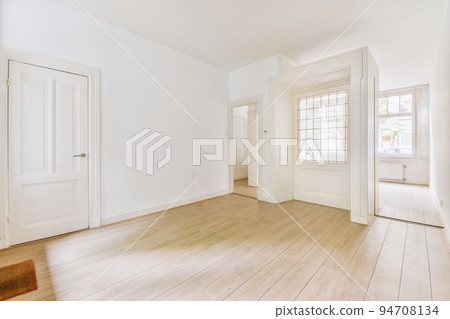 Plastic window and radiator on white wall in empty light room at home Plastic window and radiator on white wall in empty light room at home 94708134