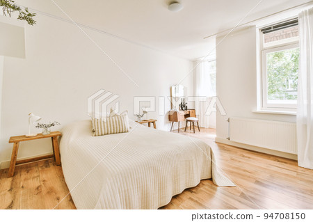 Home interior design of bedroom with bed and wooden wardrobe placed in corner near window in modern apartment Home interior design of bedroom with bed and wooden wardrobe placed in corner near window in modern apartment 94708150