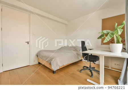 Modern home interior design of small mansard bedroom with white walls and soft cozy bed and minimalist style shelves in daylight with illumination 94708221