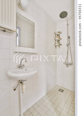 Sinks with mirrors and shower box with glass door in modern bathroom with white tiled walls 94708331