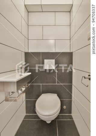 Modern home interior design of white bathroom with open bathtub and shower separated from toilet by partition wall Modern home interior design of white bathroom with open bathtub and shower separated from toilet by partition wall 94708337