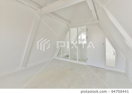A cozy and spacious mansard styled empty room in a luxury house A cozy and spacious mansard styled empty room in a luxury house 94708441