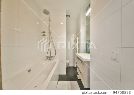 White ceramic sink and mirror with illumination in bathroom designed in minimal style White ceramic sink and mirror with illumination in bathroom designed in minimal style 94708858