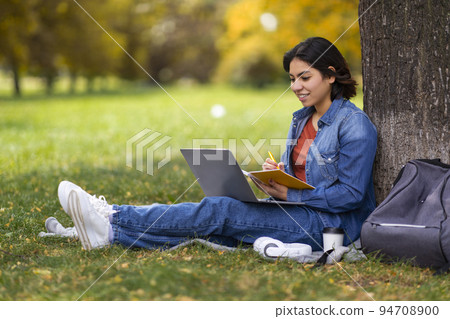 Remote Lesson. Beautiful Young Arab Female Student Study Outdoors With Laptop 94708900