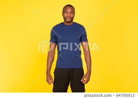 Motivated Black Sportsman Looking At Camera Standing On Yellow Background 94708913