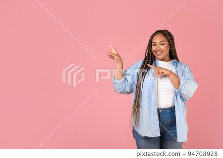 African Woman Pointing Fingers Aside At Copy Space, Pink Background African Woman Pointing Fingers Aside At Copy Space, Pink Background 94708928