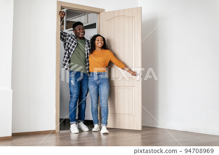 Black Spouses Hugging Posing In Opened Door Of New House Black Spouses Hugging Posing In Opened Door Of New House 94708969