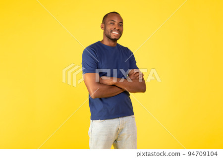 African American Millennial Guy Posing Crossing Hands Over Yellow Background African American Millennial Guy Posing Crossing Hands Over Yellow Background 94709104