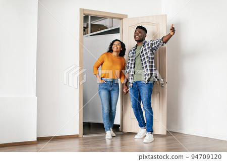 Black Family Couple Choosing And Buying New House Standing Indoor Black Family Couple Choosing And Buying New House Standing Indoor 94709120