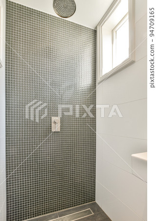 Glass partition between shower tap and wall hung toilet in modern restroom at home Glass partition between shower tap and wall hung toilet in modern restroom at home 94709165