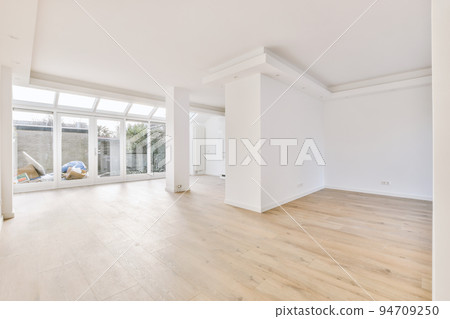 Plastic window and radiator on white wall in empty light room at home Plastic window and radiator on white wall in empty light room at home 94709250