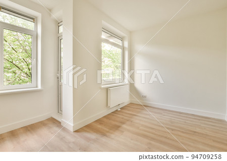 Plastic window and radiator on white wall in empty light room at home Plastic window and radiator on white wall in empty light room at home 94709258