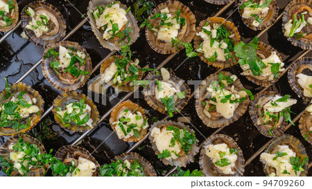 Limpets molluscs with garlic parsley butter Limpets molluscs with garlic parsley butter 94709260