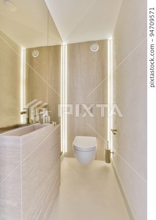 Interior of contemporary bathroom with shabby beige walls and partitions and white door at home 94709571