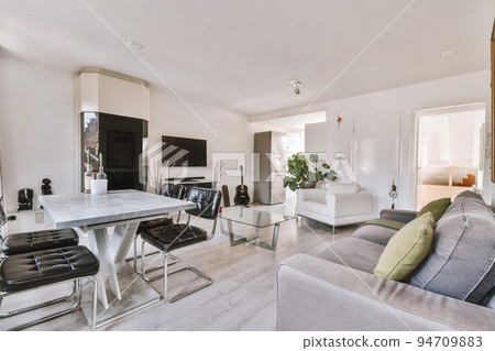 Interior of spacious room with chests of drawers in apartment designed in minimal style Interior of spacious room with chests of drawers in apartment designed in minimal style 94709883