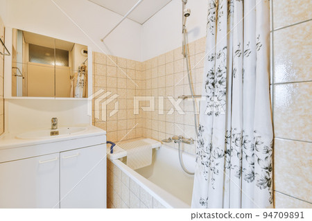 White ceramic sink and mirror with illumination in bathroom designed in minimal style White ceramic sink and mirror with illumination in bathroom designed in minimal style 94709891