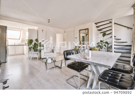 Interior of spacious room with chests of drawers in apartment designed in minimal style 94709892