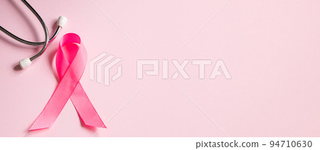 Breast Cancer Awareness Month. Pink ribbon and stethoscope on colored background. Women's health care concept. Symbol of fight against oncology. 94710630