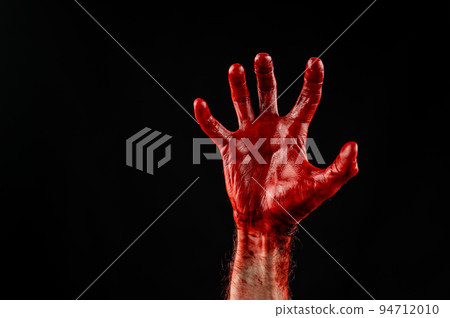 Male palm stained with blood on a black background. 94712010