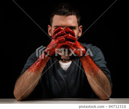 Portrait of a man with bloody hands handcuffed. Portrait of a man with bloody hands handcuffed. 94712318