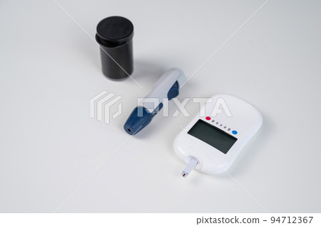 Home blood glucose test kit. Glucometer, lancet pen, needles and text strips. Home blood glucose test kit. Glucometer, lancet pen, needles and text strips. 94712367