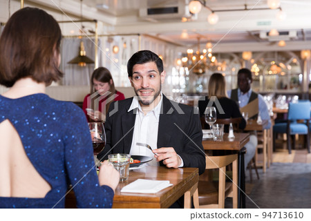 Happy man with girlfriend in restaurant 94713610