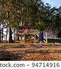 Young woman heading to a cabin in the woods 94714916
