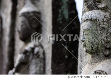 An old tombstone with a Buddha image An old tombstone with a Buddha image 94714968