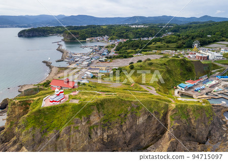 Hiyoriyama Lighthouse with beautiful red and white standing at the tip of a steep cliff | Otaru City, Hokkaido 94715097