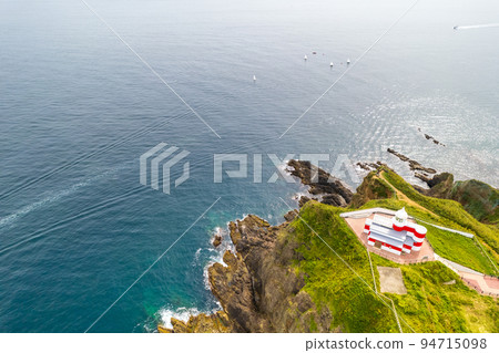 Hiyoriyama Lighthouse with beautiful red and white standing at the tip of a steep cliff | Otaru City, Hokkaido 94715098