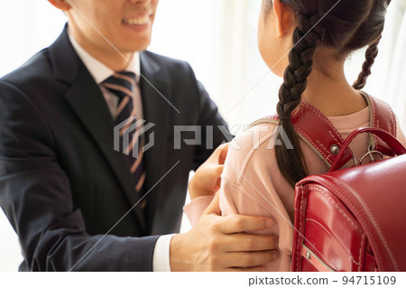 A man in a suit and an elementary school student having a conversation A man in a suit and an elementary school student having a conversation 94715109