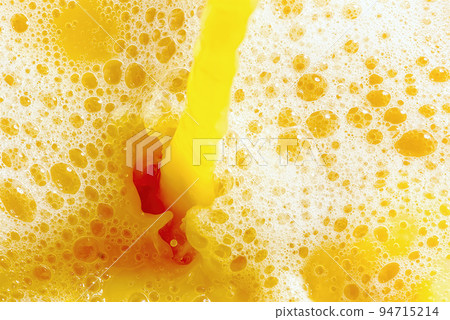 Closeup of splashing orange juice, top view. Splash of fresh sweet orange, mango, fruit juice. 94715214
