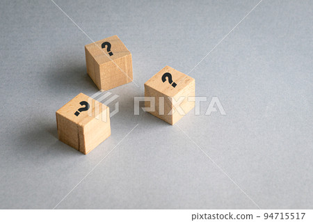 Wooden cube block shape with sign question mark on them. Wooden cube block shape with sign question mark on them. 94715517