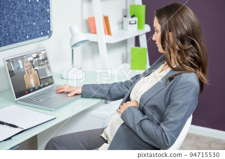 Caucasian businesswoman sitting at desk using laptop having video call with female colleague 94715530