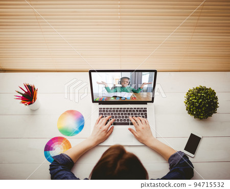 Caucasian businesswoman sitting at desk using laptop having video call 94715532