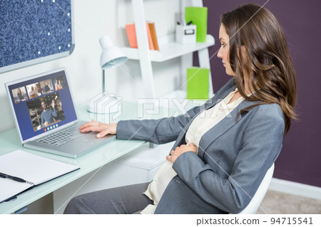 Caucasian businesswoman sitting at desk using laptop having video call with group of colleagues 94715541