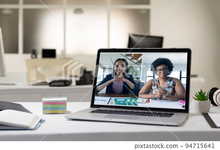 Female businesswomen having video call on screen of laptop on desk 94715641