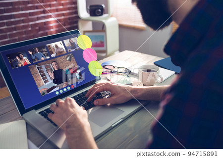 Caucasian man siting at desk, using laptop, having video call with coworkers 94715891