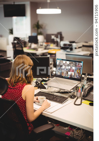 Caucasian woman having video call with coworkers Caucasian woman having video call with coworkers 94715906