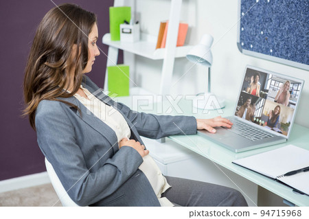 Caucasian businesswoman sitting at desk using laptop having video call with colleagues Caucasian businesswoman sitting at desk using laptop having video call with colleagues 94715968
