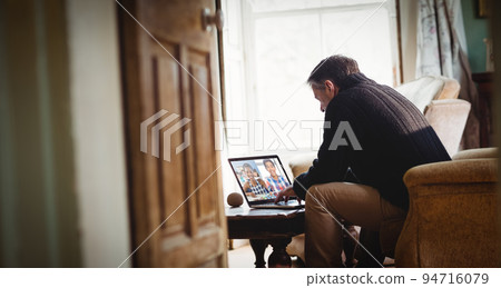 Senior caucasian man using laptop at home having video call with diverse students Senior caucasian man using laptop at home having video call with diverse students 94716079