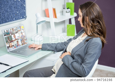 Caucasian businesswoman sitting at desk using laptop having video call 94716198