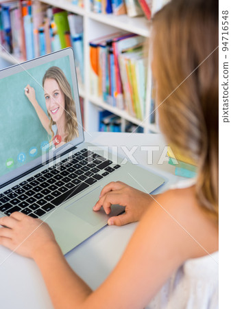 Female student having a videocall with female teacher on laptop at home Female student having a videocall with female teacher on laptop at home 94716548