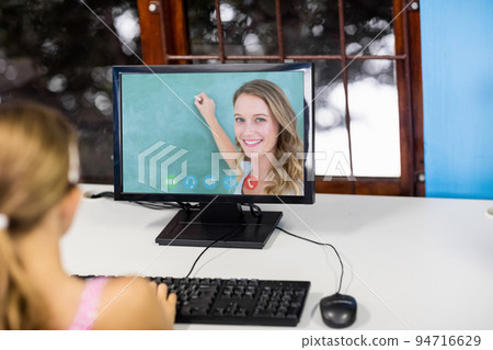 Caucasian schoolgirl using computer on video call with female teacher 94716629